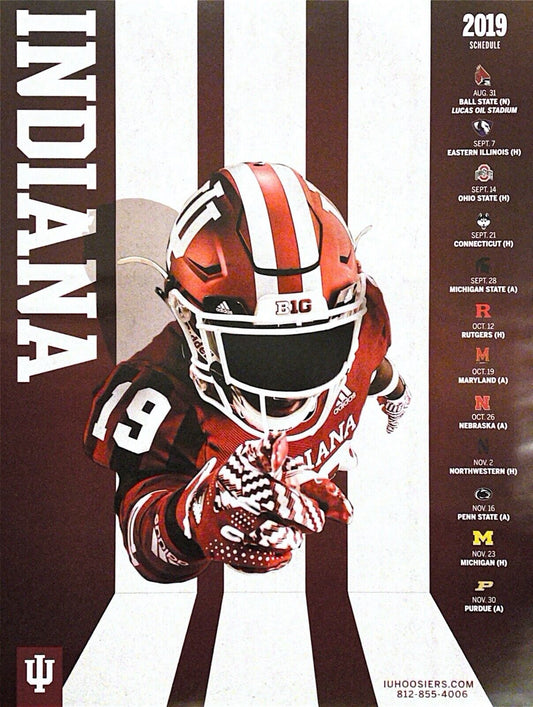 A promotional poster for the Indiana University Hoosiers 2019 football schedule featuring an image of a football player in a red and white uniform with the number 19 and the text 'INDIANA' on it. The poster also includes the names and locations of the university's football games for the upcoming season.