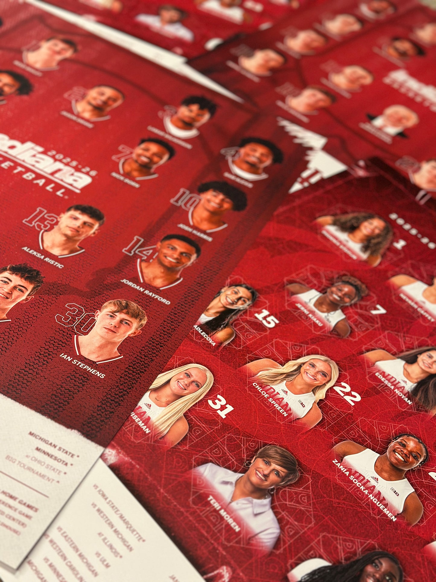 Collection of sports trading cards with player images on a red background