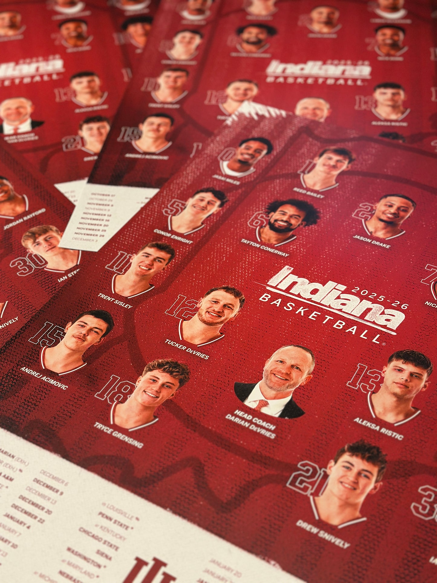 Collection of Indiana basketball yearbooks with player photos on a red background
