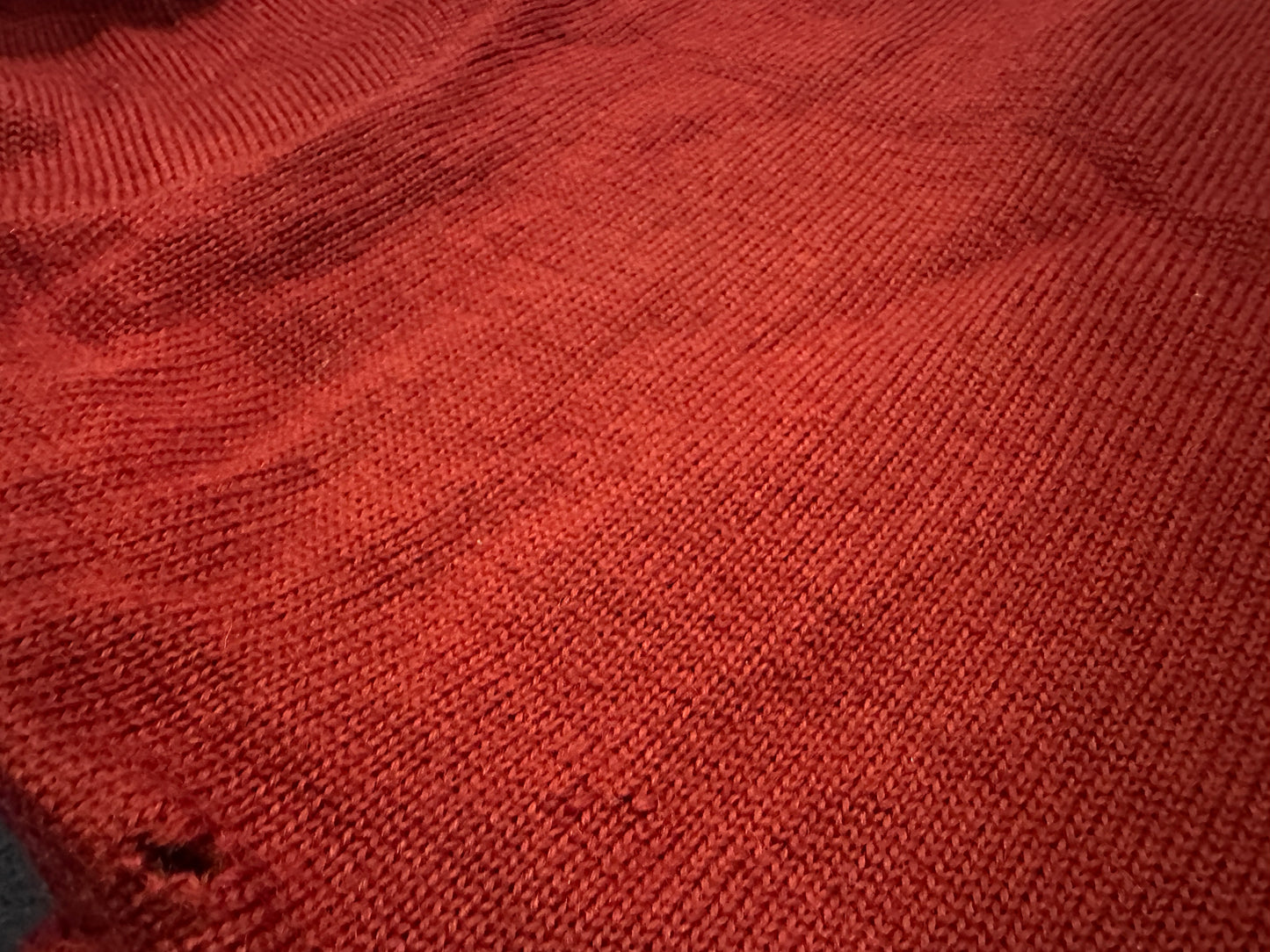 Close up of sweater hole.