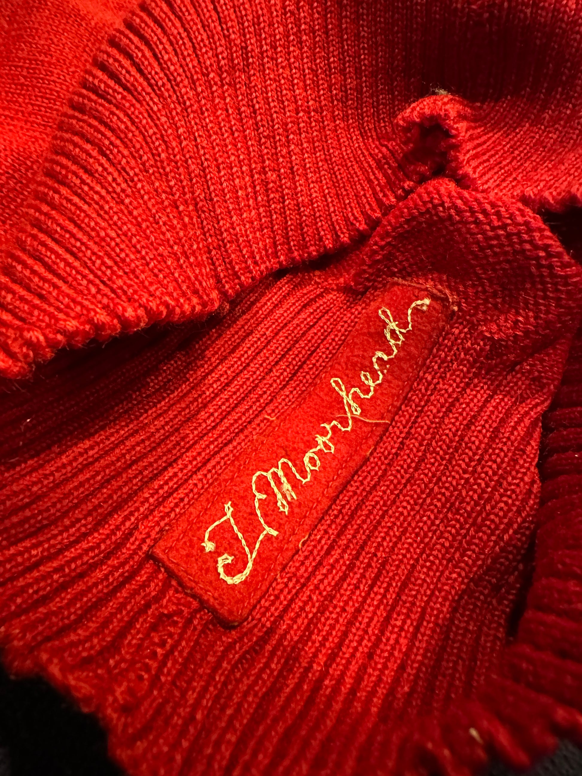 Name embroidered in inner sweater.